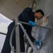 Sailors aboard the USS John Finn conduct topside preservation efforts in the Indian Ocean