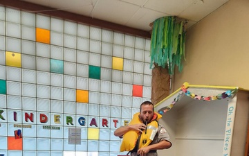 Tulsa District park ranger visits library to read Bobber the Water Safety dog book to children