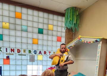 Tulsa District park ranger visits library to read Bobber the Water Safety dog book to children