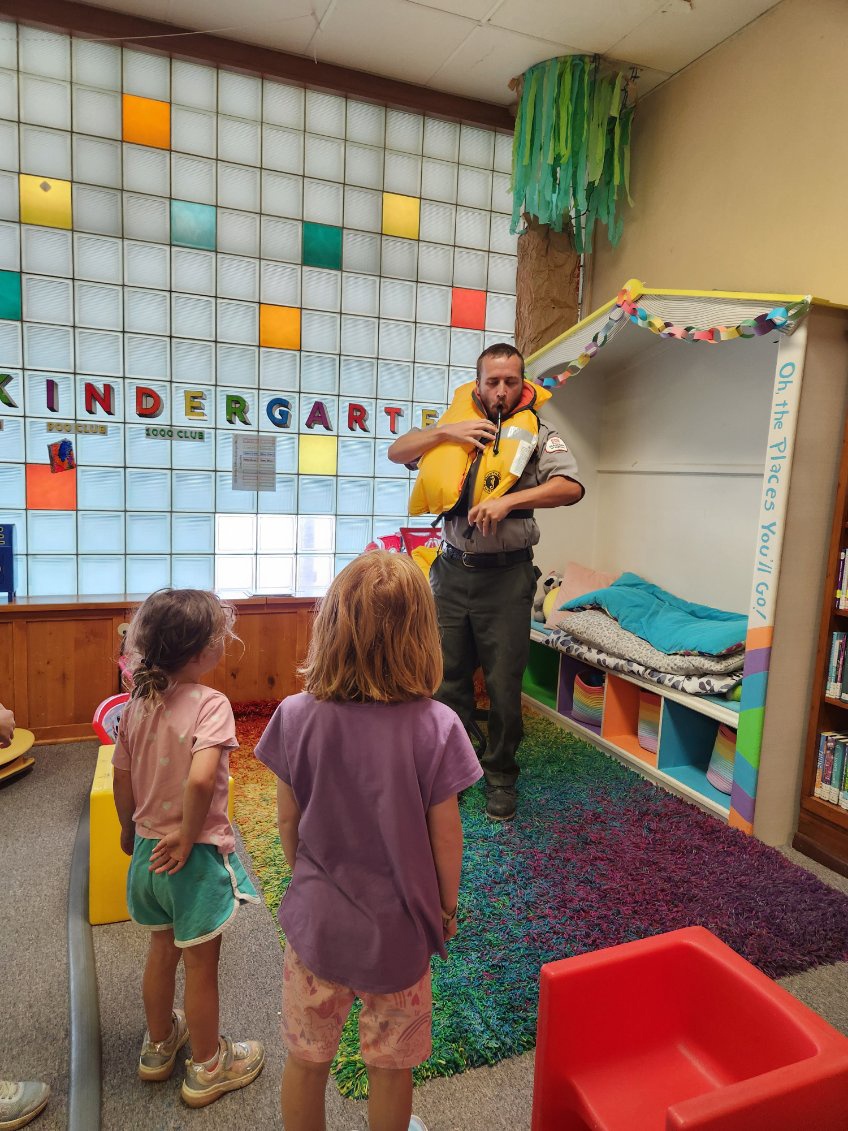 Tulsa District park ranger visits library to read Bobber the Water Safety dog book to children