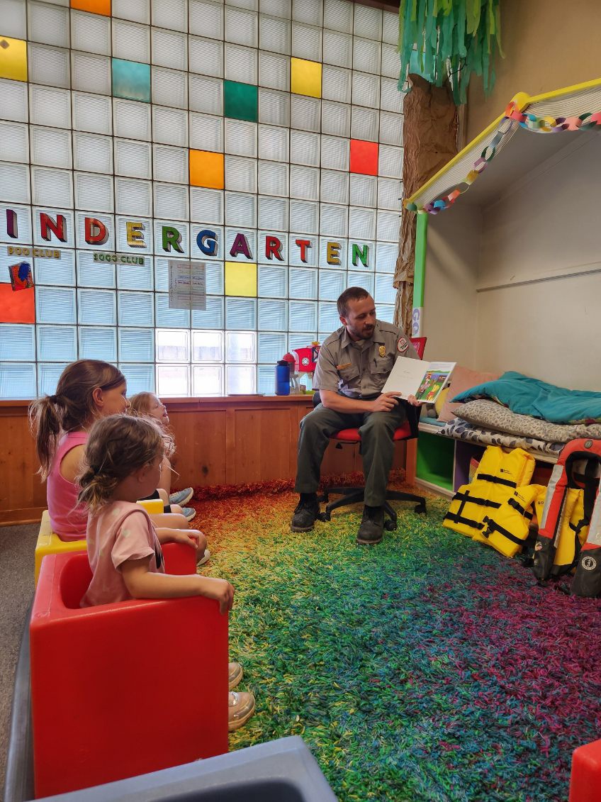 Tulsa District park ranger visits library to read Bobber the Water Safety dog book to children