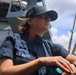 QMSN Lisa Gourlay observes the horizon from the weather decks