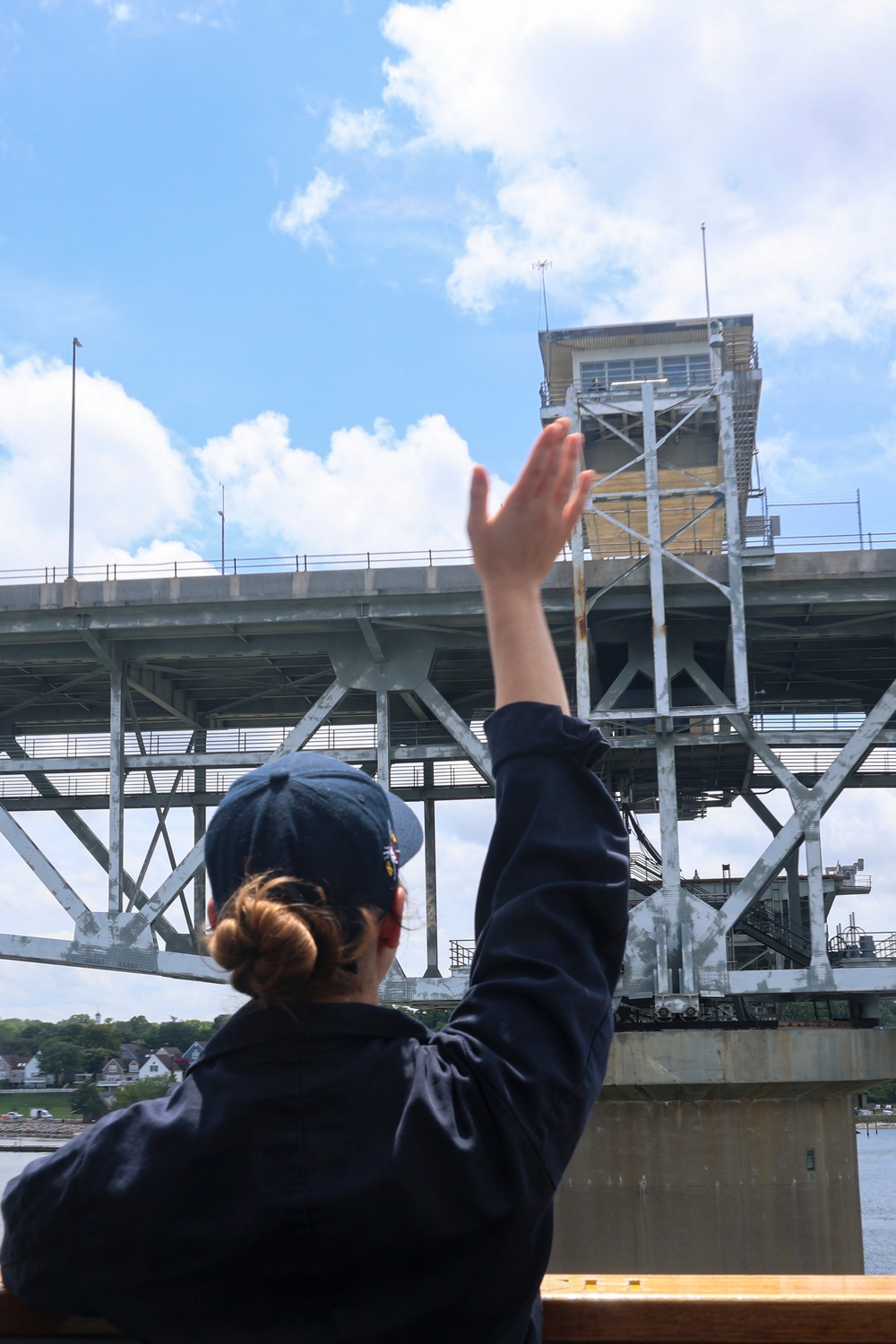 Midshipman Ashley Sarno waves to Coleman Memorial Bridge personnel from the portside bridge wing