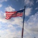 USS Bulkeley Sailors salute the ensign during morning colors on the aft flight deck
