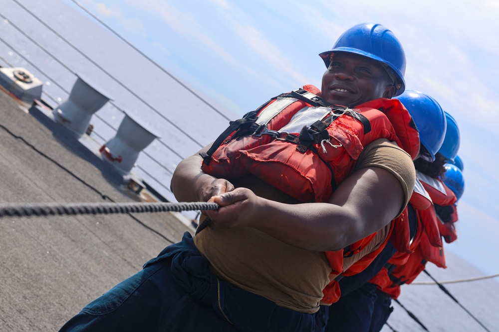 IC2 Paul Anato maintain tension on the phone and distance with fellow Sailors