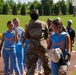 Col. Kerya Reyes throws first pitch in Little League Softball Southeast Tournament