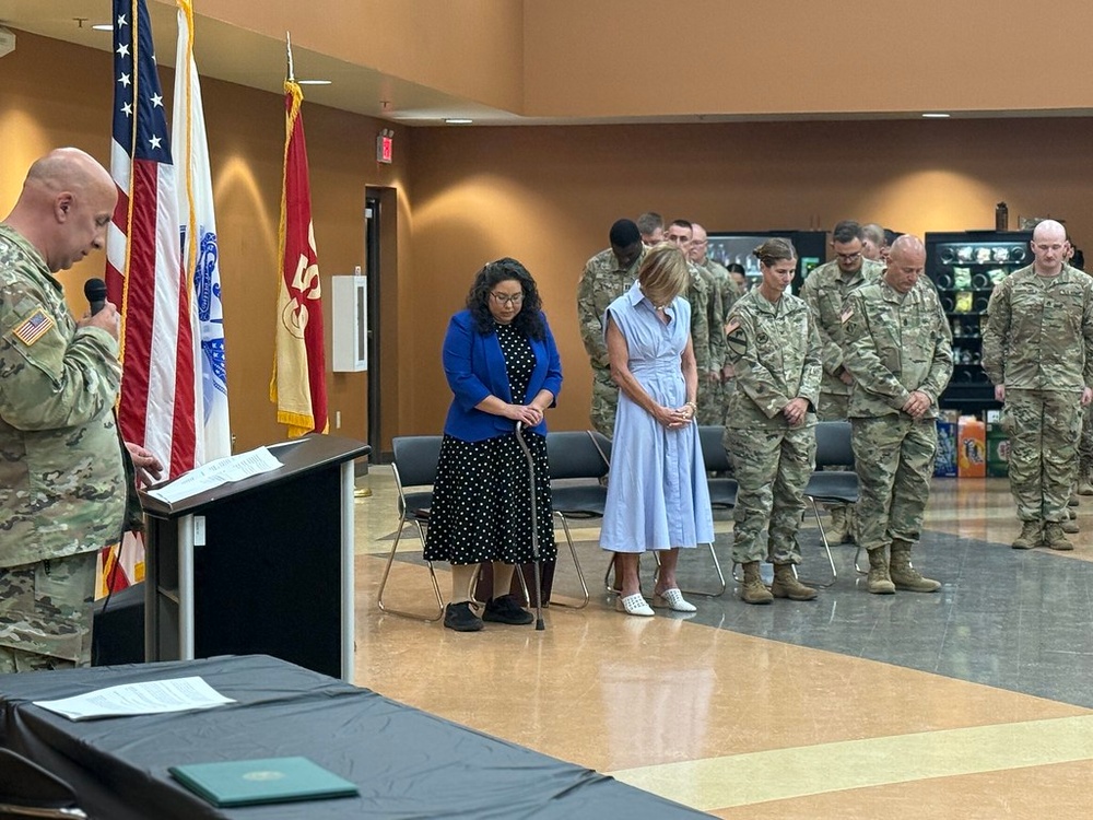 Soldiers and guests of the 650th RSG bow their heads in prayer