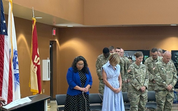 Soldiers and guests of the 650th RSG bow their heads in prayer