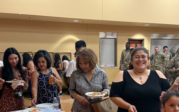 Families and guests of the 650th Regional Support Group Soldiers grab food