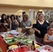Families and guests of the 650th Regional Support Group Soldiers grab food