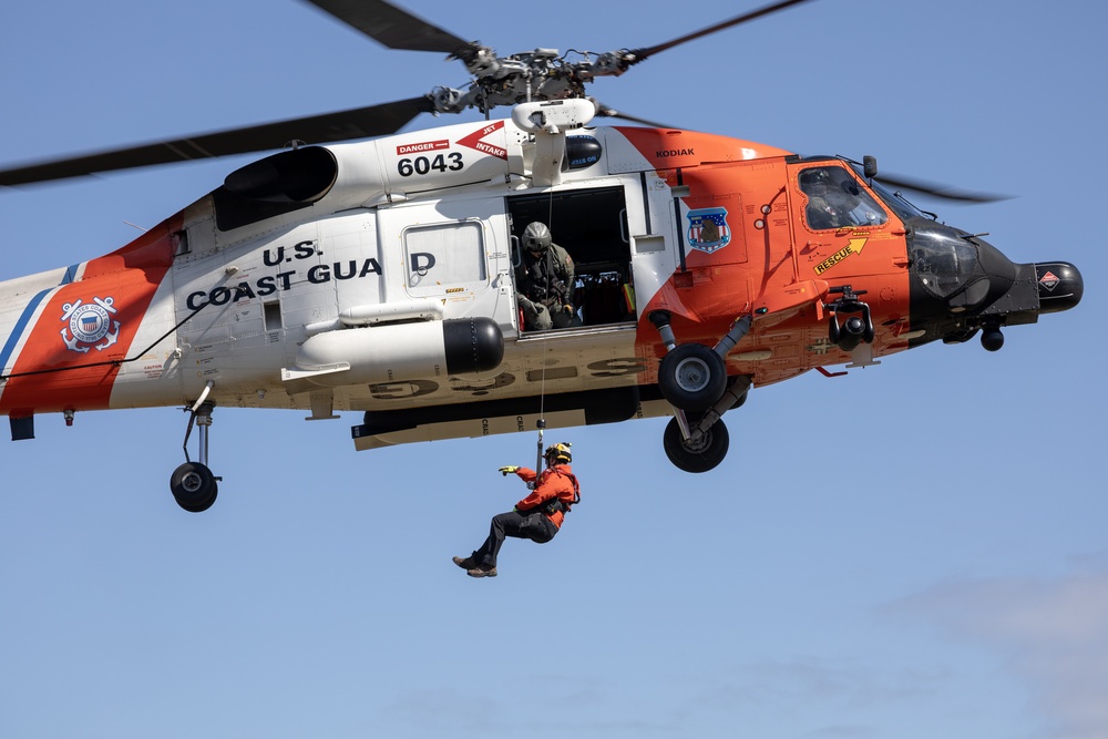 Alaska based Coast Guard aviators showcase rescue demonstration during multi-agency hoist symposium