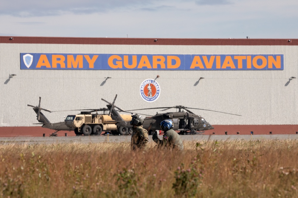 Alaska based Coast Guard aviators showcase rescue demonstration during multi-agency hoist symposium