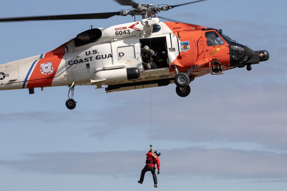 Alaska based Coast Guard aviators showcase rescue demonstration during multi-agency hoist symposium
