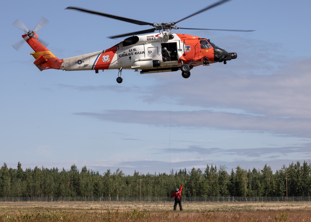 Alaska based Coast Guard aviators showcase rescue demonstration during multi-agency hoist symposium