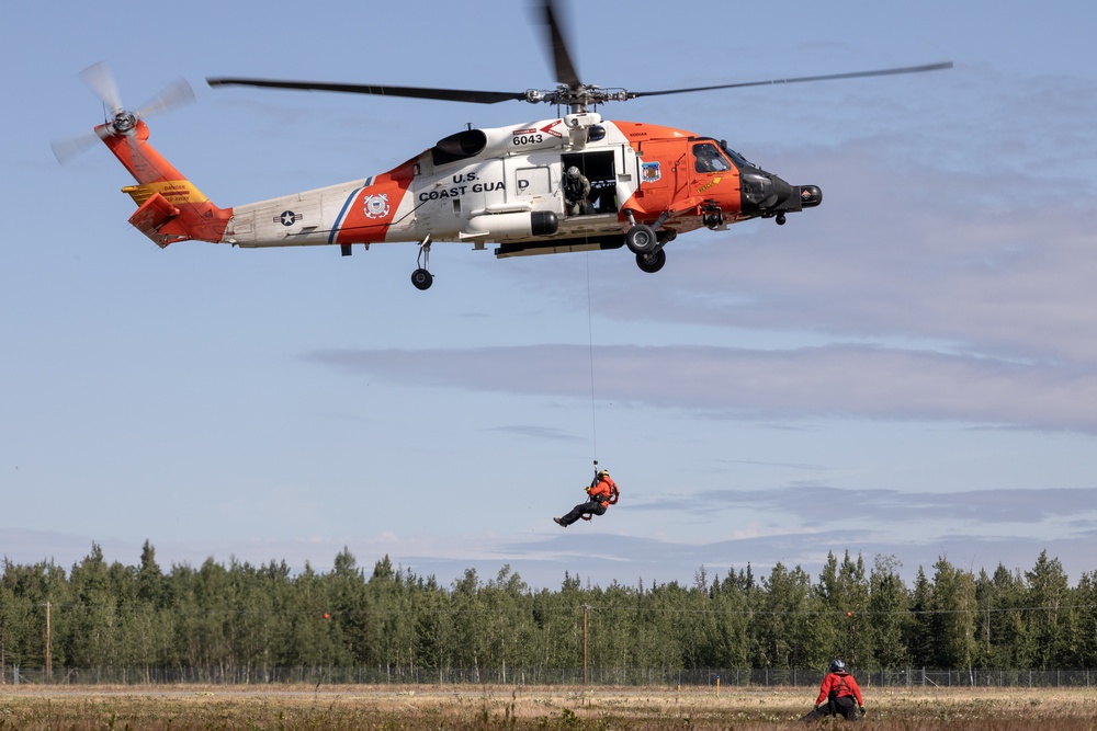 Alaska based Coast Guard aviators showcase rescue demonstration during multi-agency hoist symposium