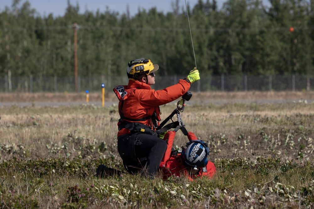 Alaska based Coast Guard aviators showcase rescue demonstration during multi-agency hoist symposium