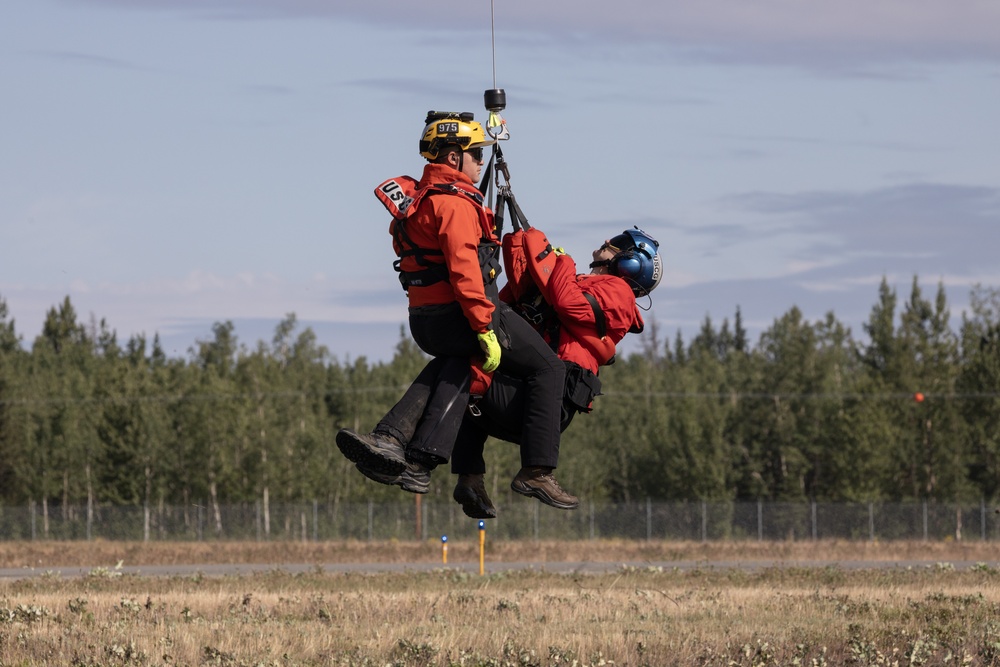 Alaska based Coast Guard aviators showcase rescue demonstration during multi-agency hoist symposium