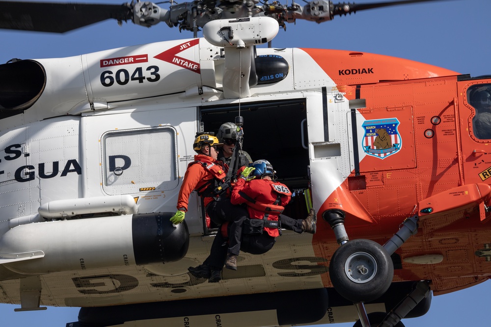 Alaska based Coast Guard aviators showcase rescue demonstration during multi-agency hoist symposium