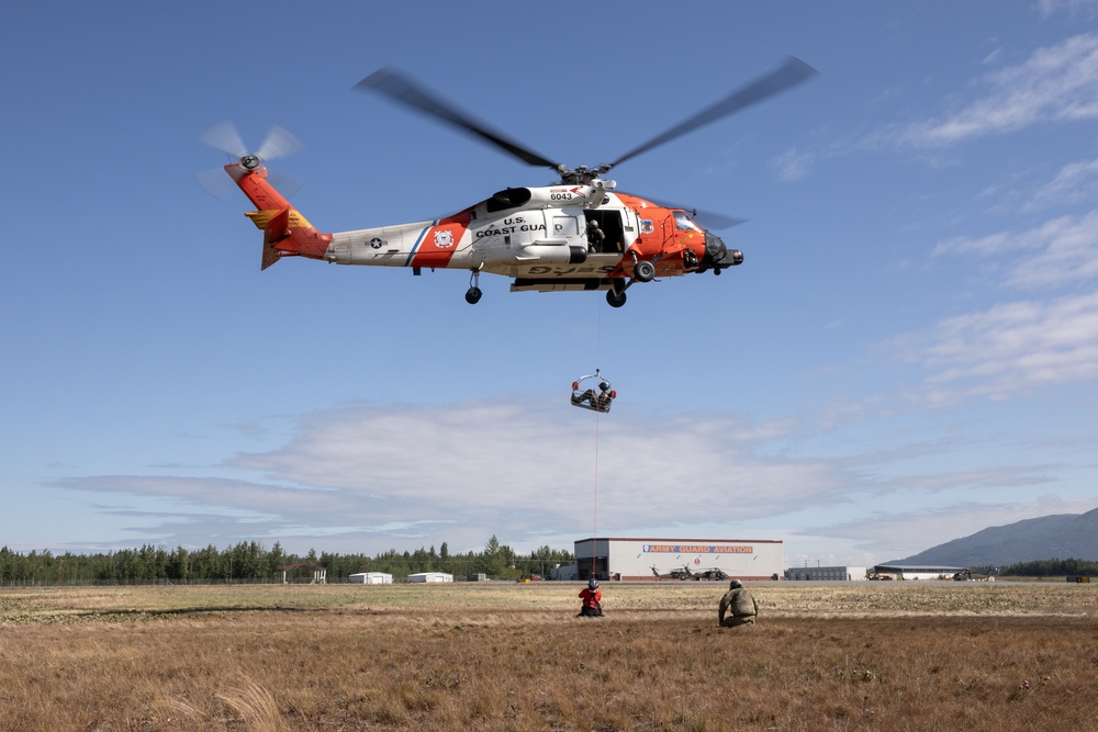 Alaska based Coast Guard aviators showcase rescue demonstration during multi-agency hoist symposium