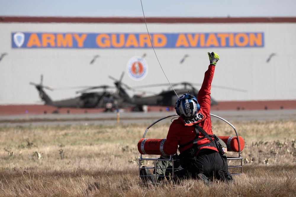 Alaska based Coast Guard aviators showcase rescue demonstration during multi-agency hoist symposium