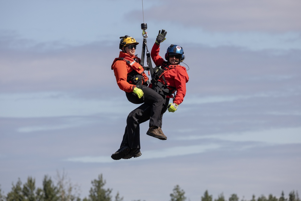 Alaska based Coast Guard aviators showcase rescue demonstration during multi-agency hoist symposium