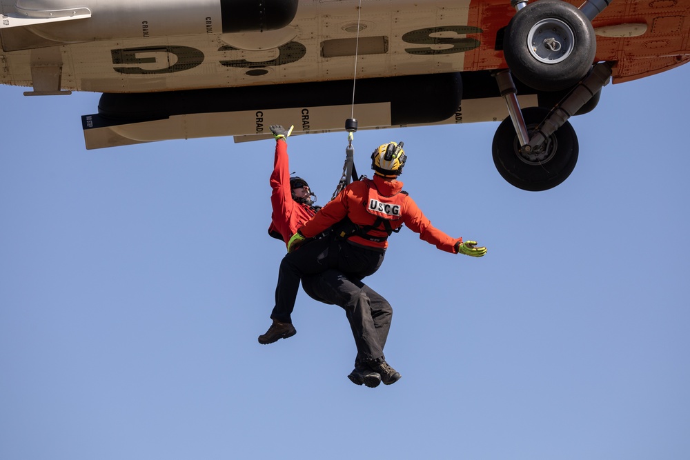 Alaska based Coast Guard aviators showcase rescue demonstration during multi-agency hoist symposium