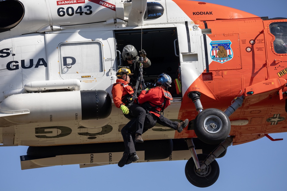 Alaska based Coast Guard aviators showcase rescue demonstration during multi-agency hoist symposium