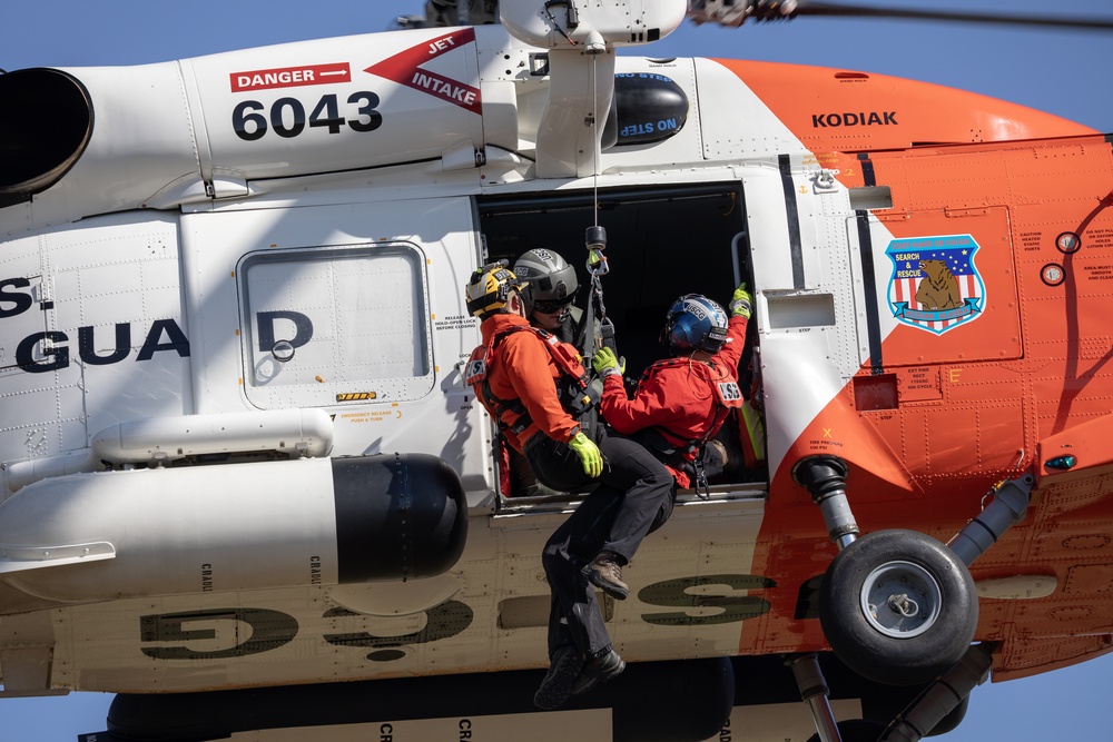 Alaska based Coast Guard aviators showcase rescue demonstration during multi-agency hoist symposium