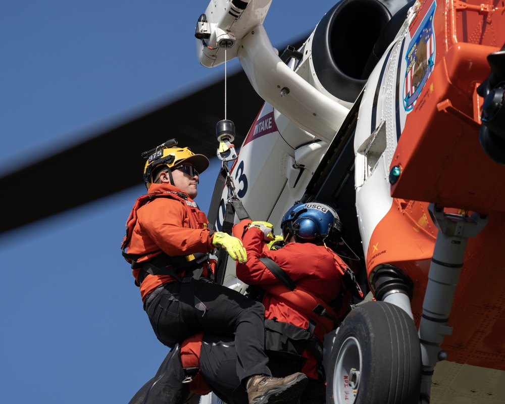 Alaska based Coast Guard aviators showcase rescue demonstration during multi-agency hoist symposium