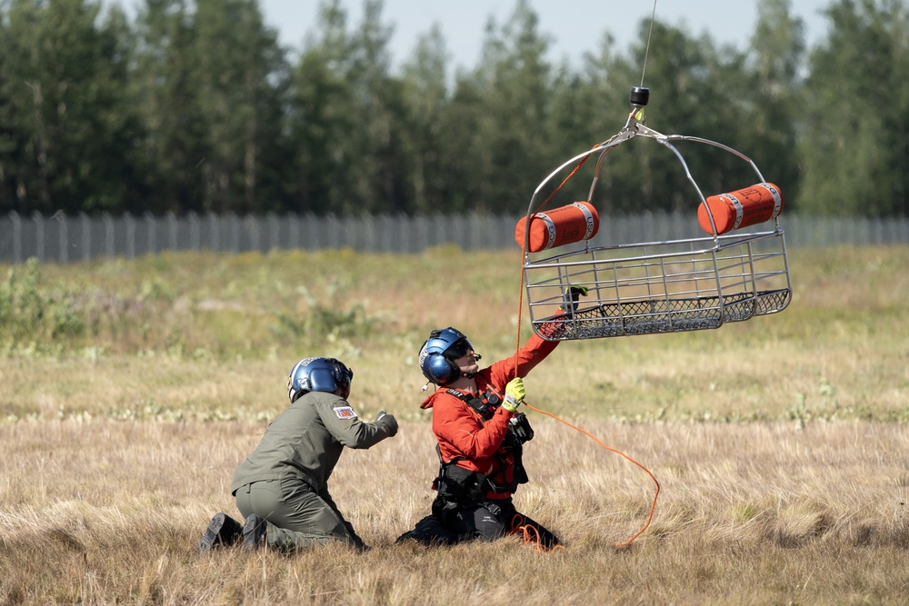 Alaska based Coast Guard aviators showcase rescue demonstration during multi-agency hoist symposium