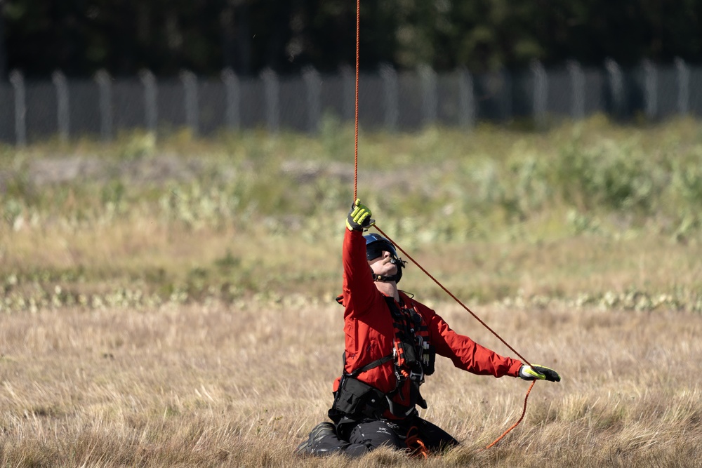 Alaska based Coast Guard aviators showcase rescue demonstration during multi-agency hoist symposium