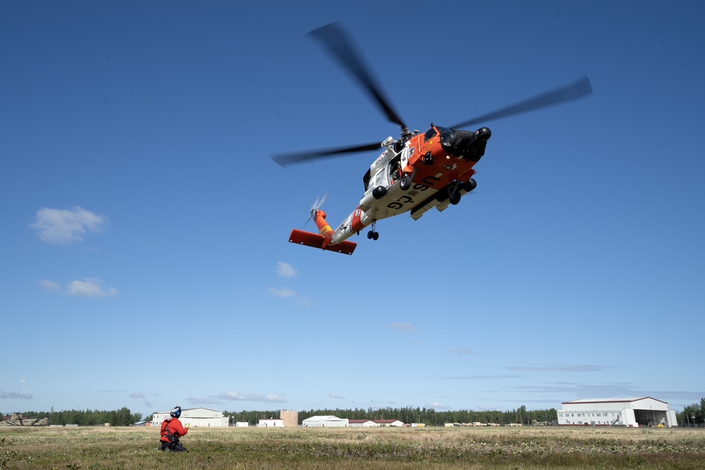Alaska based Coast Guard aviators showcase rescue demonstration during multi-agency hoist symposium
