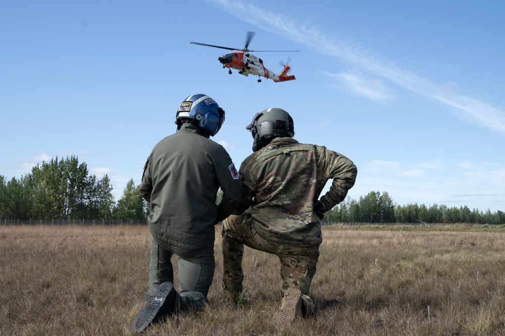 Alaska based Coast Guard aviators showcase rescue demonstration during multi-agency hoist symposium