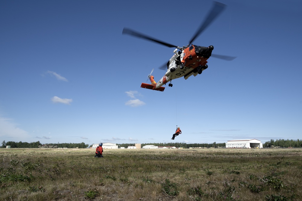 Alaska based Coast Guard aviators showcase rescue demonstration during multi-agency hoist symposium