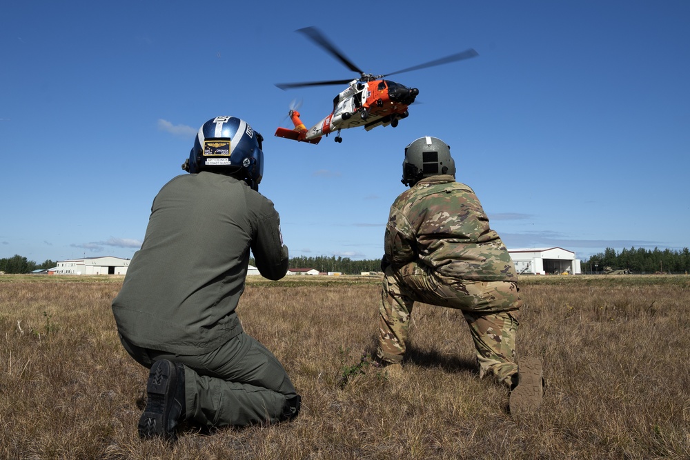 Alaska based Coast Guard aviators showcase rescue demonstration during multi-agency hoist symposium