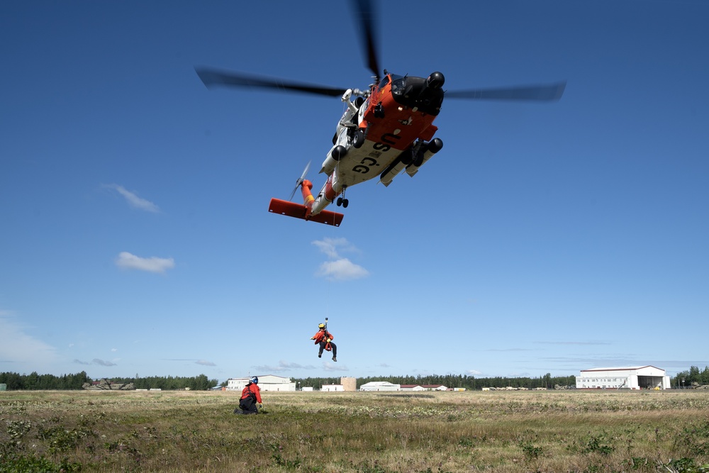 Alaska based Coast Guard aviators showcase rescue demonstration during multi-agency hoist symposium