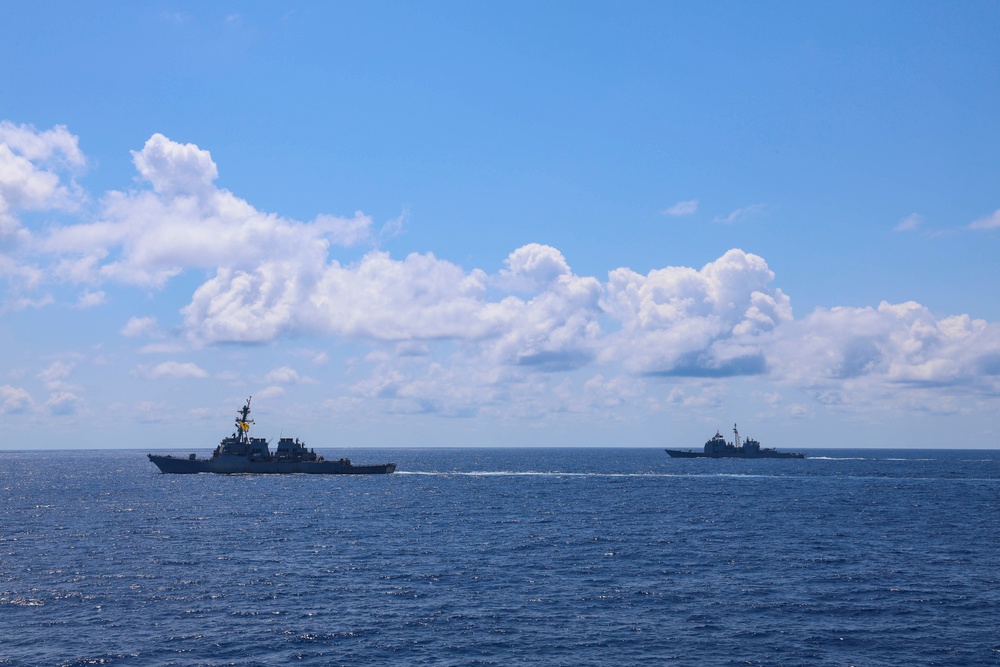 USS Stout and USS Normandy maneuver at sea alongside the USS Bulkeley
