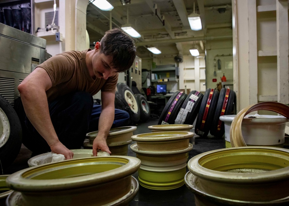 USS Gerald R. Ford (CVN 78) Sailor Works in Tire Shop