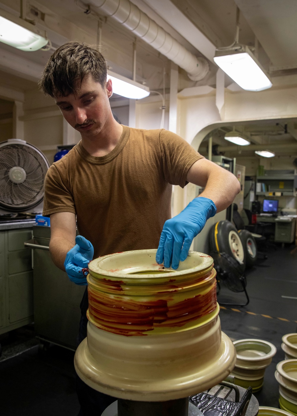 USS Gerald R. Ford (CVN 78) Sailor Lubricates Tire Rims