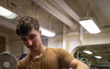 USS Gerald R. Ford (CVN 78) Sailor Lubricates Tire Rims