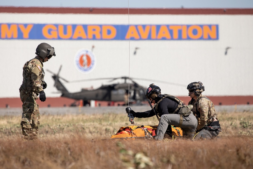 Alaska Air National Guardsmen showcase rescue demonstration during multi-agency hoist symposium