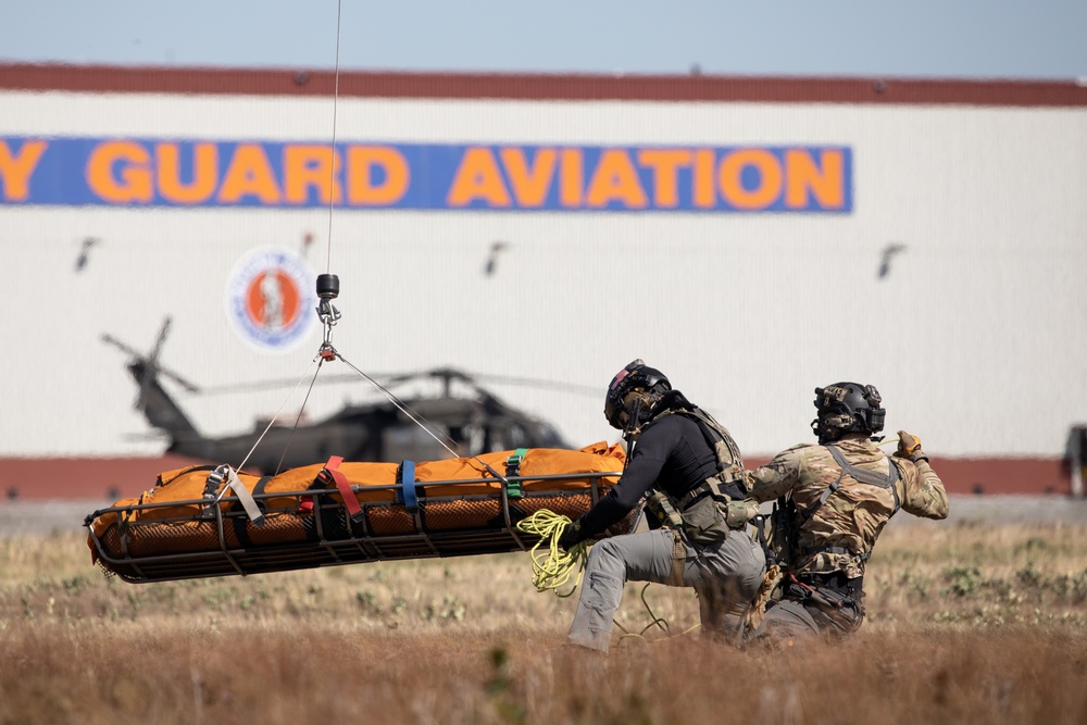 Alaska Air National Guardsmen showcase rescue demonstration during multi-agency hoist symposium