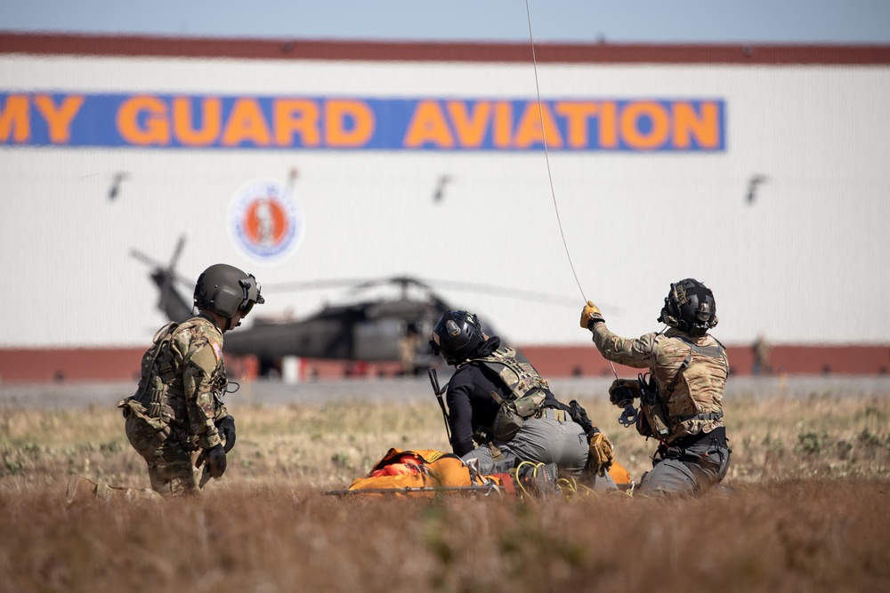 Alaska Air National Guardsmen showcase rescue demonstration during multi-agency hoist symposium