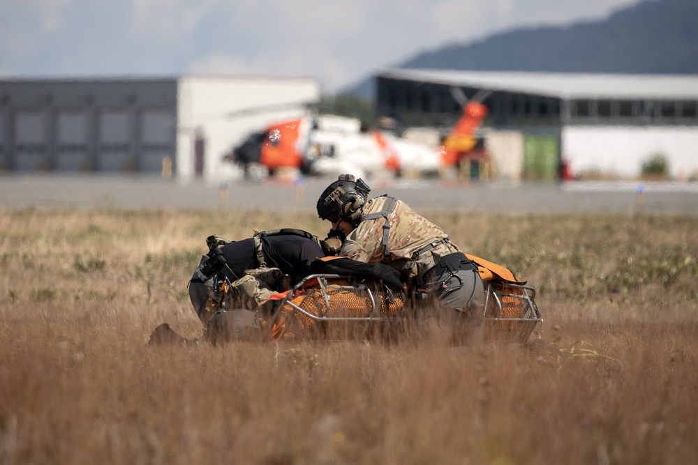 Alaska Air National Guardsmen showcase rescue demonstration during multi-agency hoist symposium