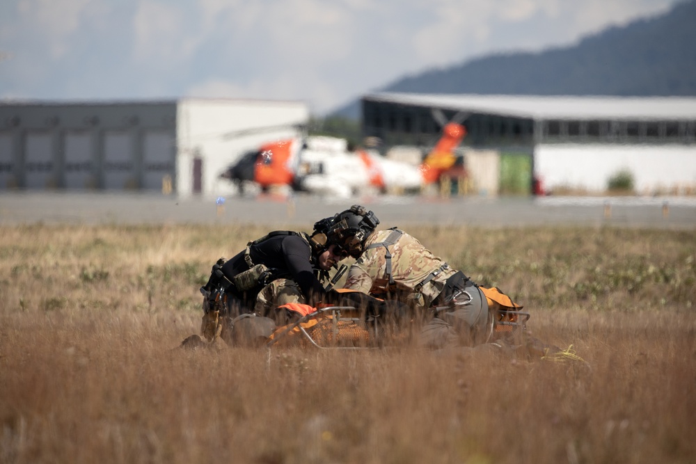 Alaska Air National Guardsmen showcase rescue demonstration during multi-agency hoist symposium