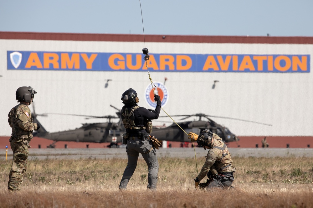 Alaska Air National Guardsmen showcase rescue demonstration during multi-agency hoist symposium