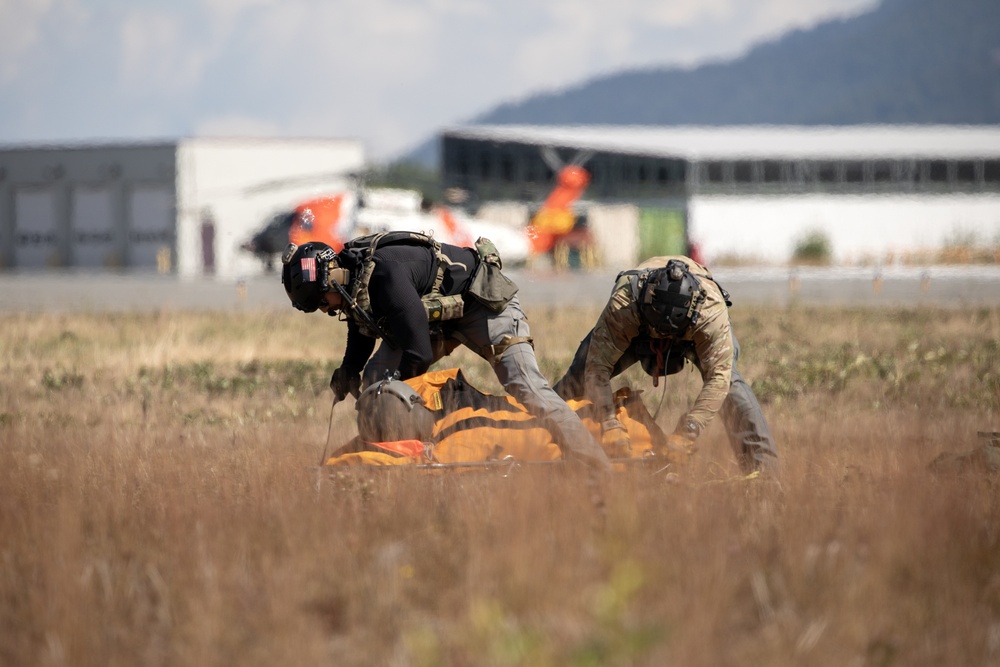 Alaska Air National Guardsmen showcase rescue demonstration during multi-agency hoist symposium