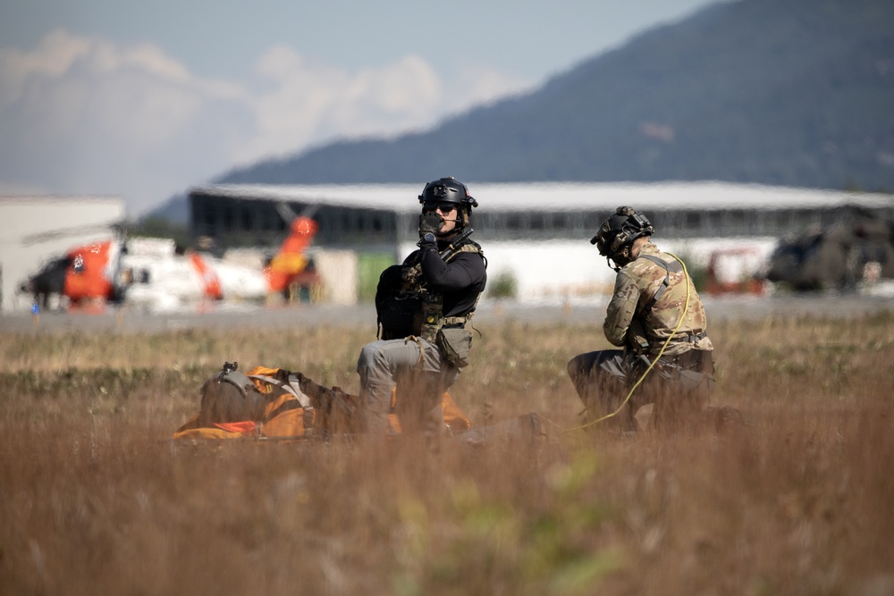 Alaska Air National Guardsmen showcase rescue demonstration during multi-agency hoist symposium