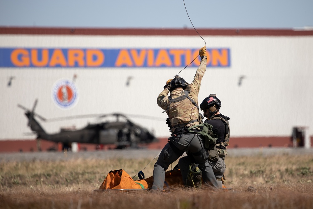Alaska Air National Guardsmen showcase rescue demonstration during multi-agency hoist symposium