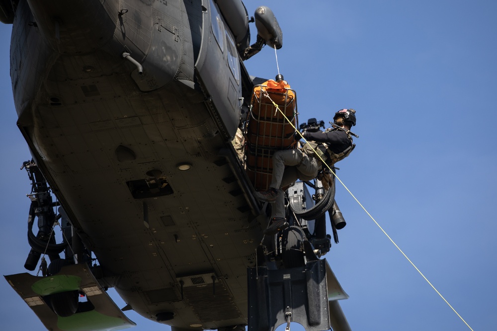 Alaska Air National Guardsmen showcase rescue demonstration during multi-agency hoist symposium